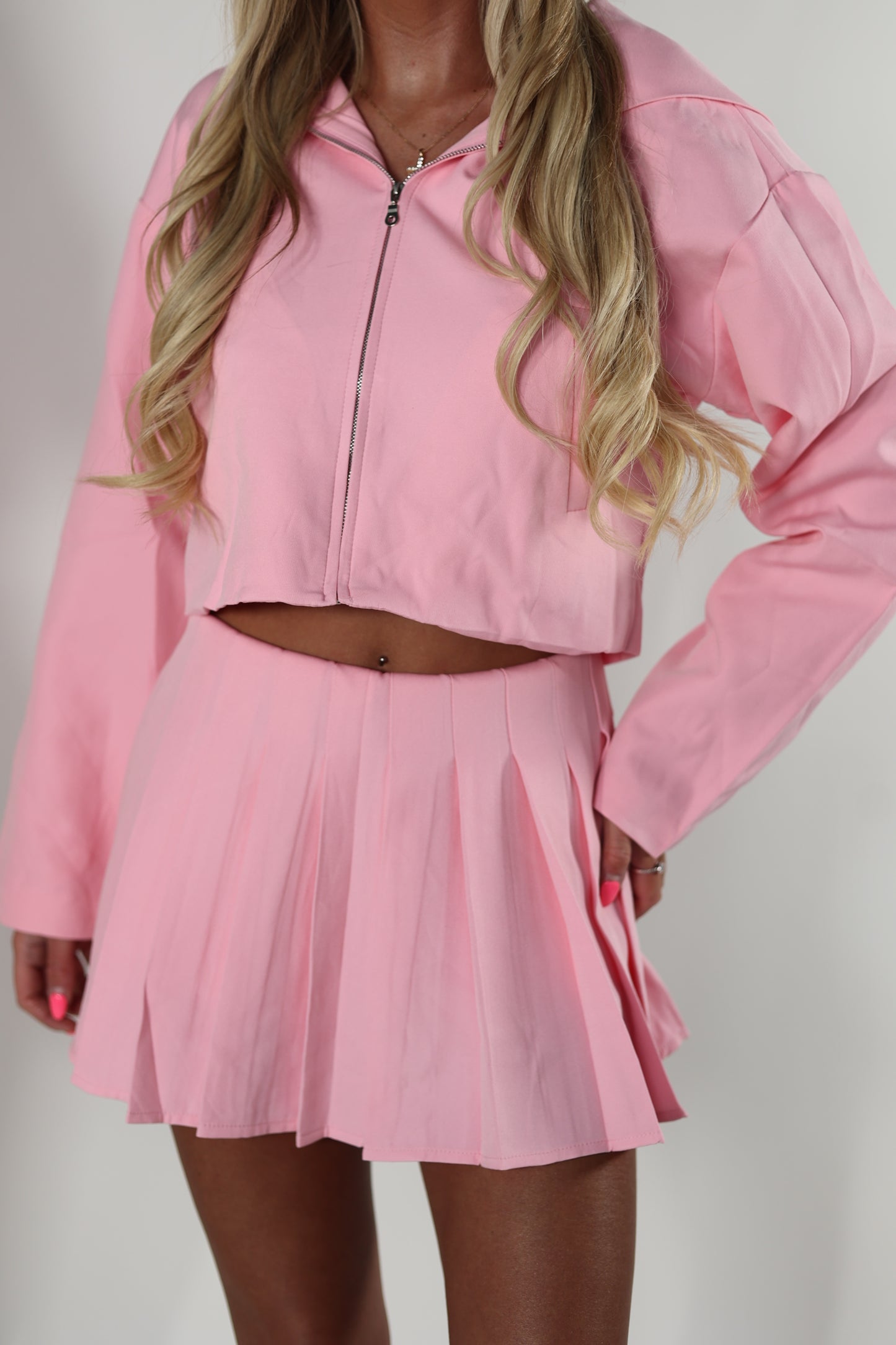 Pink tailored zip up jacket and pleated skirt set